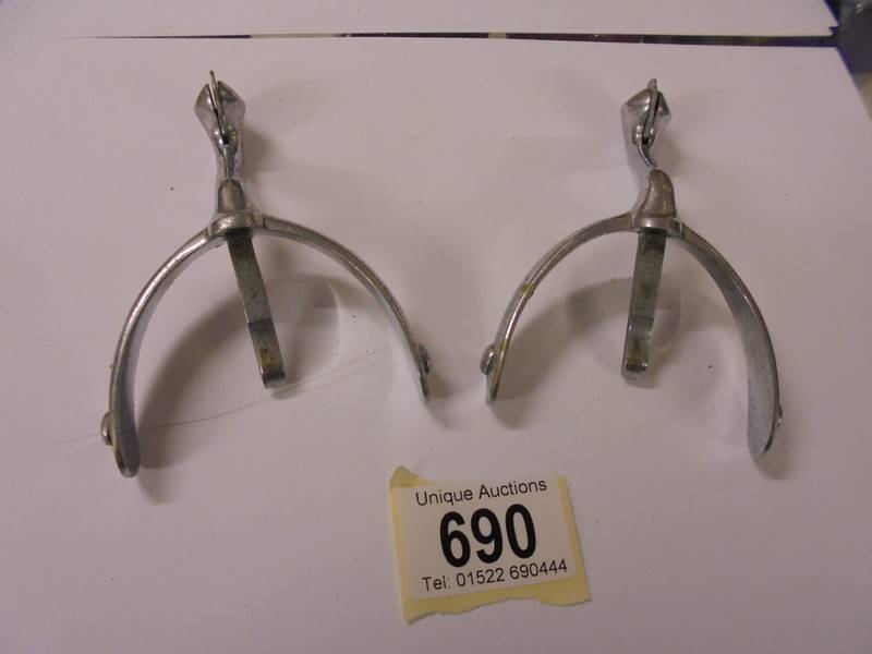 A pair of vintage chrome plated riding spurs.