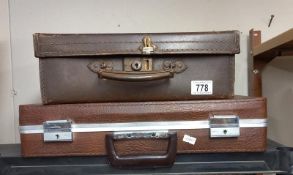 A small vintage suitcase and a brief case.