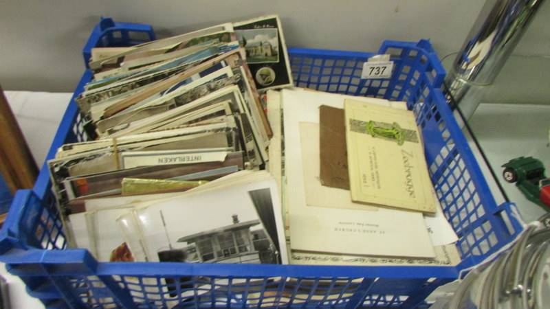 A box of postcards, ephemera, some stamps etc.,