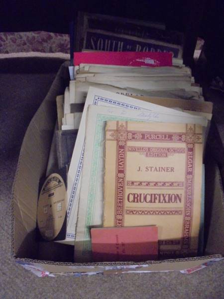 A box of assorted sheet music.