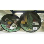 A pair of hand painted pottery plates.