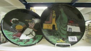 A pair of hand painted pottery plates.