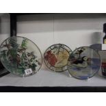 Three circular glass light catchers including two featuring birds.