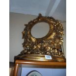 An ornate gilded circular mirror frame. (no glass). COLLECT ONLY.