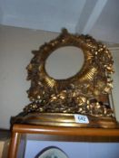An ornate gilded circular mirror frame. (no glass). COLLECT ONLY.