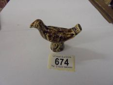 A ceramic bird whistle.