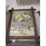 A late Victorian carved wooden frame with a traditional Christmas scene of children in the snow,
