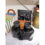 Two cased pairs of binoculars.