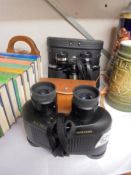 Two cased pairs of binoculars.