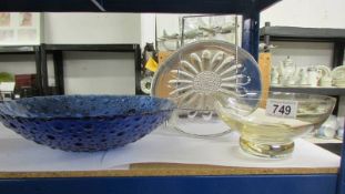 A glass cake plate and two glass bowls.