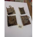 Four old locks with keys.