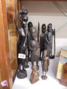 Ten carved wood tribal figures.