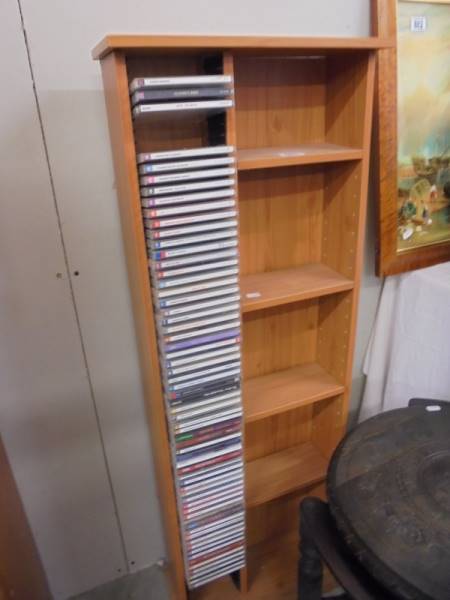 A CD shelf and large quantity of CD's.