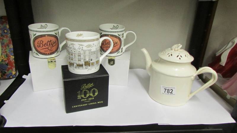 Three boxed Betty's tea rooms York mugs and a Leeds Betty teapot.