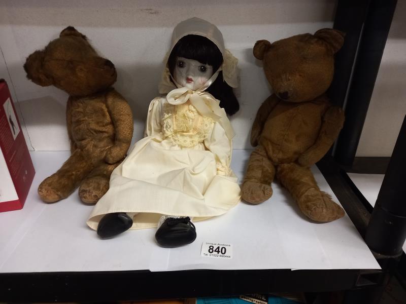 Two vintage teddy bears and a doll.