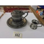 A pewter inkwell with glass liner and a 1/24 pewter measure.