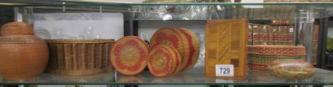 A shelf of wicker and other boxes.