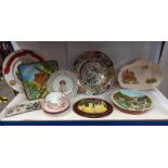 A shelf of interesting collector's and other plates.