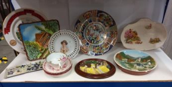 A shelf of interesting collector's and other plates.