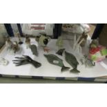 A shelf of miscellaneous items including piggy bank, mostly animal related items etc.,