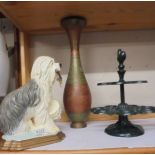 A cast iron old English sheep dog door stop, a cast iron egg stand and a metal vase.