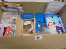 A box of assorted jewellery making materials.