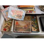 A quantity of vintage jigsaw puzzles (completeness unknown) marbles etc.,