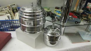 A silver coloured biscuit barrel/ice bucket and a tea caddy with lid.