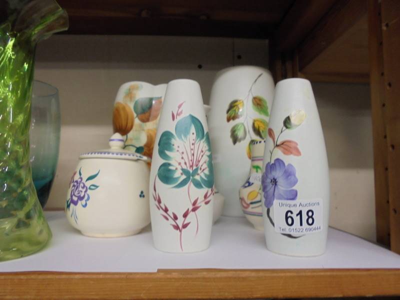 Four vases, a jam pot, salt and pepper pots including Poole Pottery.