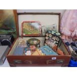 A vintage suitcase and a quantity of vintage tins.