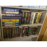 2 shelves of Modern thrillers by Clive Cussler, Jeffrey Deaver, Stieg Larssan & James Patterson