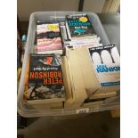 A crate of paperback fiction mixed genres