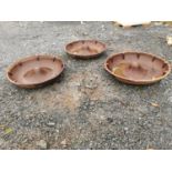 Three cast iron pig feeders