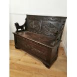 Carved oak monks bench in the Tudor style.