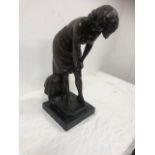 Bronze figure of a woman.