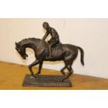 Bronze horse and jockey statue.