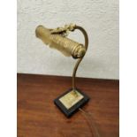 Embossed brass desk lamp.