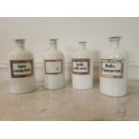 Collection of four early 20th C. opaline glass chemist jars.