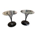 Pair of black metal and glass tables.