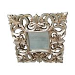 Decorative silvered resin wall mirror.