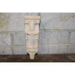 Corbel decorated with face laurel wreath and scroll