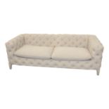 Upholstered deep button three seater Chesterfield sofa.