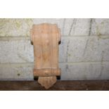 Mahogany corbel decorated with scroll .
