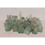 Miscellaneous collection of clear glass bottles.