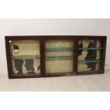 Three door glazed wall display cabinet with wooden back.