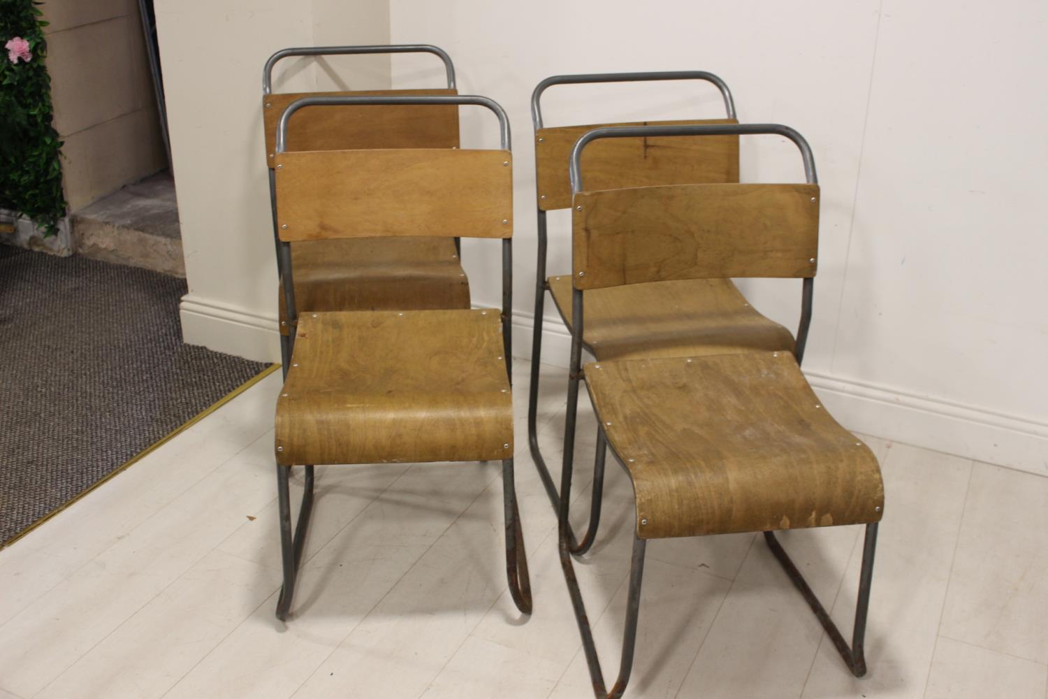 Set of four metal and wood stacking chairs