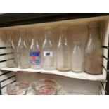Collection of twelve glass milk bottles