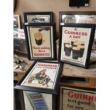 Three framed Guinness advertising prints.