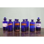 Collection of eight 19th C. Bristol blue chemist bottles.