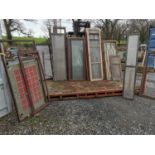 Large collection of mahogany and pine chemist shop cabinet doors.